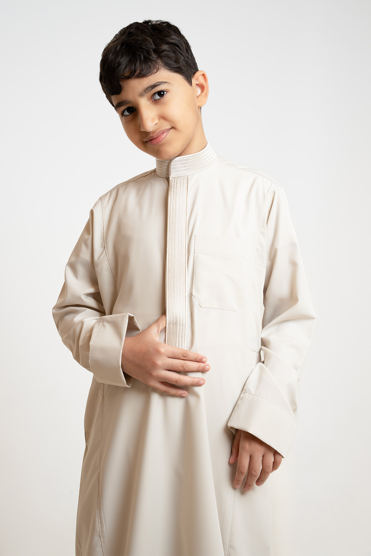 zakhrafat-youth-thobe-saudi-beige-collar-lines-embroidery-light-fabric-cufflinks-ramadan-eid-3 Al Shiaka Light beige embroidered youth thobe - Image 1